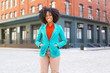 © Jason Homa/Blend Images - Mixed race woman standing on city street
