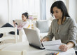 © JGI/Jamie Grill/Blend Images - Woman paying bills online