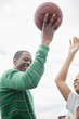 © JGI/Jamie Grill/Blend Images - Father and son playing basketball outdoors