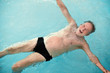 © Rolf Bruderer/Blend Images - Senior man floating in swimming pool