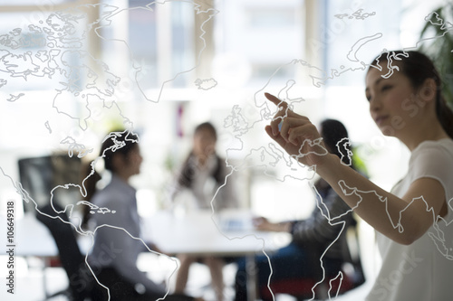 Fotografie, Obraz Business women map of the world are pointing finger