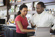 © Don Mason/Blend Images - African American couple using tablet computer in restaurant