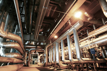 equipment, cables and piping as found inside of a modern industr