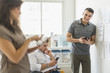 © JGI/Tom Grill/Blend Images - Hispanic business people using technology in office
