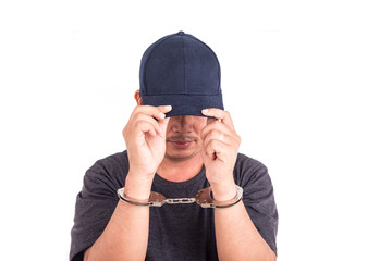 Close up man with handcuffs on hands isolated on white backgroun