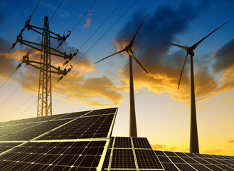 solar panels with wind turbines and electricity pylon at sunset. clean energy concept.