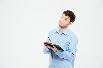 Businessman writing notes in clipboard