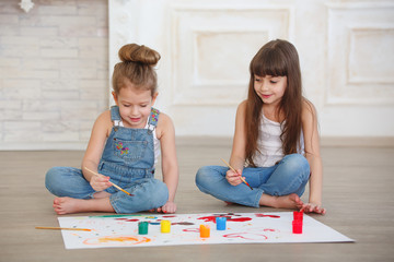 two beautiful little girls paint
