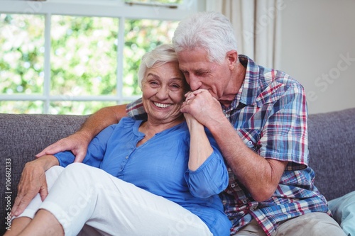 Loving Senior Man Kissing Wife Hand Sitting On Sofa Buy This Stock
