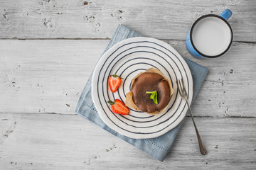 Wall Mural - Chocolate fondant  with strawberry  , mint and milk on the wooden table