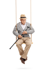 Wall Mural - Lonely senior sitting on a swing