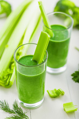 Fototapete - Healthy green smoothie on table, celery and broccoli juice mix