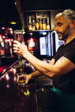 Waiter Pouring Whiskey In An Irish Pub