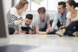© Westend61 - Group of creative professionals working on floor