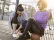 © Westend61 - Two young women with on a streetball field