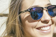 © Westend61 - Friends of young woman reflecting at her sunglasses