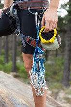 Midsection Of Woman Holding Climbing Equipment