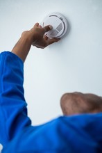 Handyman Installing Smoke Detector