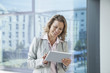 © Westend61 - Smiling businesswoman using digital tablet in office