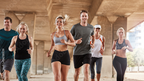 Fotografía Adults exercising with running club group