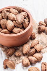 Wall Mural - Tasty almond nuts on rustic wooden background