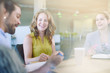 © AYAimages - Unposed group of creative business people in an open concept office brainstorming their next project.