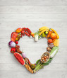 Heart symbol. Food photography of heart made from different vegetables on white wooden table. High resolution product.