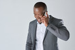 © Daxiao Productions - African business person in suit talking on mobil cell phone