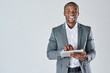 Leinwandbild Motiv Young black male professional holding tablet device smiling