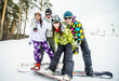 © Aleksander Rubtsov/Blend Images - Caucasian couples snowboarding posing on snowy slope