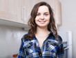 © JackF - adult female in check shirt at home kitchen