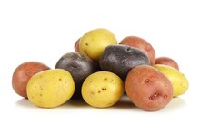 Pile Of Colorful Fresh Little Potatoes Over A White Background