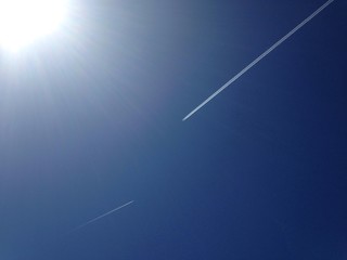 jets in clear blue sky with bright sun light