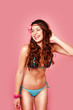 © stryjek - happy hippi style model wearing bikini on pink background in the studio smiling