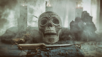 Skull Voodoo Smoke Ritual. Voodoo related objects on a table including a skull, a knife and candles. Smoke or mist.