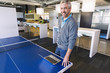 © Don Mason/Blend Images - Businessman using laptop at table tennis table in office