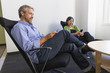 © Don Mason/Blend Images - Business people using cell phones in office