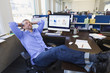 © Don Mason/Blend Images - Businessman relaxing at desk in office