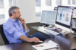 © Don Mason/Blend Images - Businessman working on computer in office