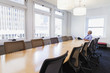 © Don Mason/Blend Images - Businessman sitting at table in conference room