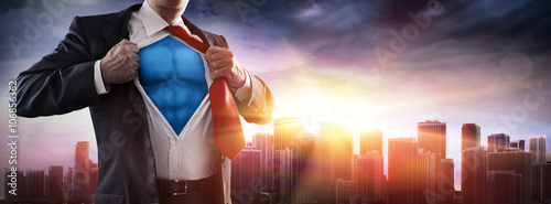Cuadros en Lienzo Businessman Superhero With Sunset In City