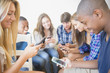 © JGI/Jamie Grill/Blend Images - Teenagers using cell phones