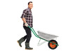 Gardener pushing an empty wheelbarrow