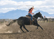 © Pete Saloutos/Blend Images - Caucasian woman using lasso on horse at rodeo