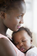 © JGI/Jamie Grill/Blend Images - Black mother holding sleeping son