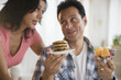 © JGI/Jamie Grill/Blend Images - Couple choosing between healthy and unhealthy snacks