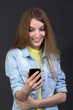 © stas_80 - Young beautiful girl reads a text message on a cell phone