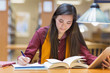 © Marc Romanelli/Blend Images - Mixed race student studying in library