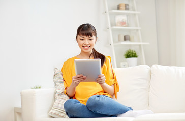 Poster - happy young asian woman with tablet pc at home