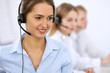 © rogerphoto - Call center. Focus on beautiful woman in headset